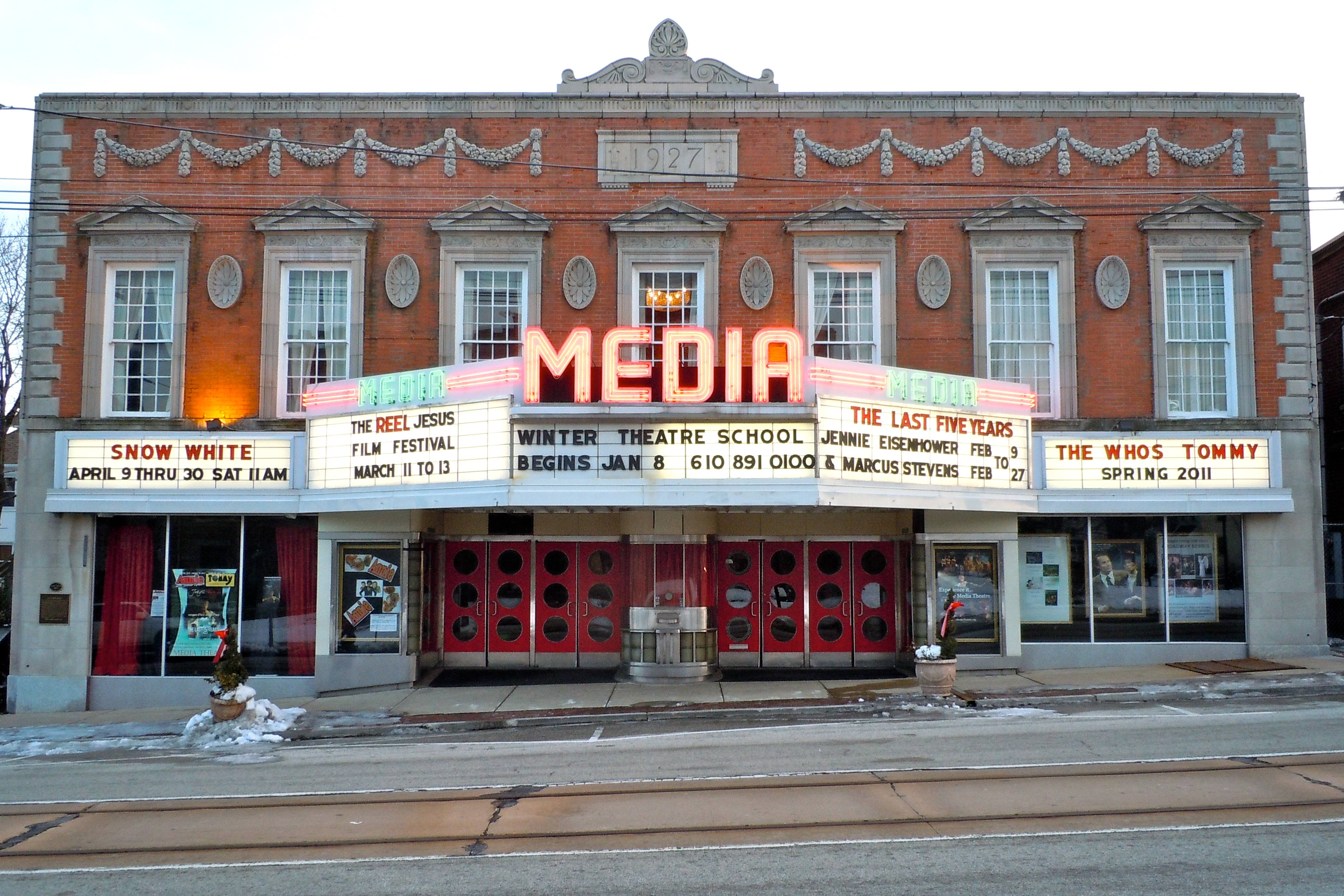 The Media Theatre on State Street, a 1927 brick building with a lit red MEDIA sign and marquees over its red front doors